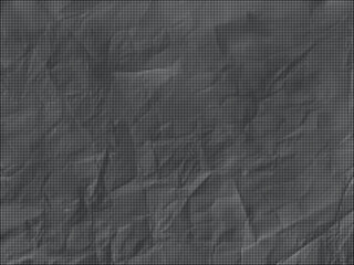 Fototapeta premium A crumpled black surface with many wrinkles and folds