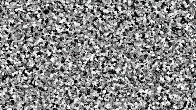 Textured surface composed of dense, irregularly shaped chips in shades of black, white, and gray.