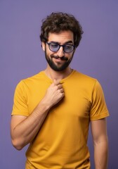 Obraz premium Thoughtful Young Man with Beard and Glasses Wearing Yellow T-shirt Against Purple Background