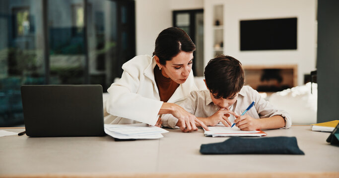 Education, family and remote work mother with son in home for business or homework task. Laptop, learning and writing with boy child and single parent woman at counter for freelance or study