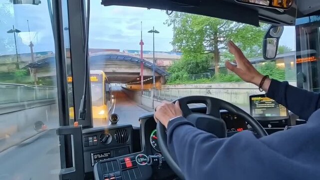 Bus driver perspective driving through city center in modern public transport vehicle, urban traffic and street view, POV