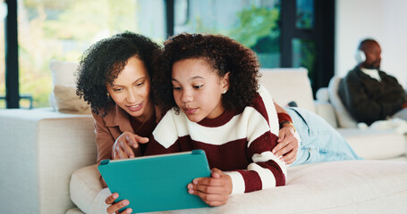 Obraz premium Mom, child or playing with tablet on sofa for entertainment, bonding or online subscription in home. Mother, daughter or kid lying with technology or app for fun game or interaction together in house