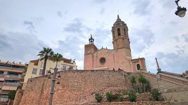 Revealing shot of the Church of Sant Bartomeu in Sitges