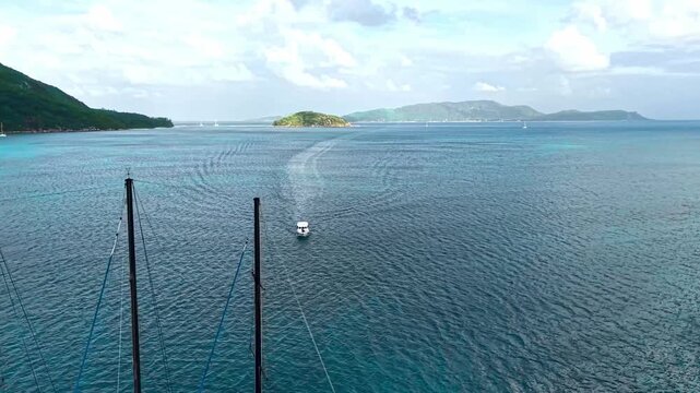 Aerial view of a large three-masted sailing yacht anchored in the turquoise waters near Praslin Ferry Harbour, Baie Ste Anne, Baie Sainte Anne, Seychelles.