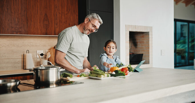 Father, girl and teaching with tablet, cooking and meal prep in home for education. Dad, child and learning recipe with tech, development or bonding in kitchen with tutorial or ingredients for dinner