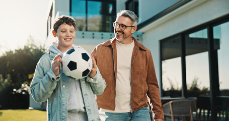 Soccer, smile and father with son outdoor for bonding, support or teaching game. Football, connection and weekend break with man and child in backyard of family home for growth, fun and care together © peopleimages.com