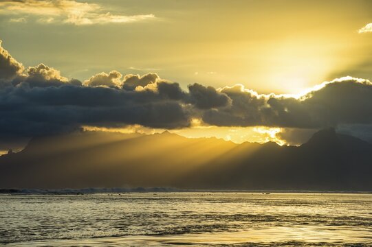 Sun rays breakig through the clouds over Moorea, Papeete, Tahiti