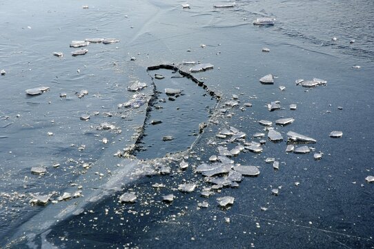 A frozen hole in a frozen ice on a lake