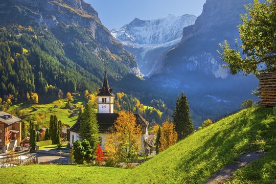 Village church in the town center with fiesch&ouml;rner 4049m in autumn, Grindelwald, L&uuml;tschinental, Bernese Oberland, Canton of Bern, Switzerland