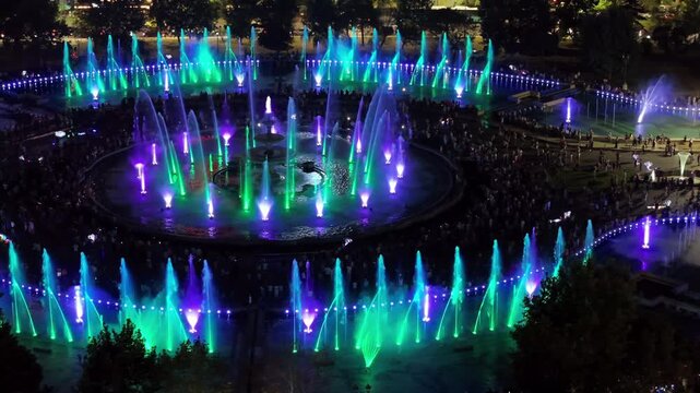 Spectacular illuminated water fountain show with synchronized lights and music at night.