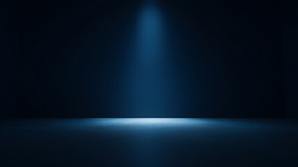 Obraz premium Empty dark blue room with a narrow soft spotlight beam from above