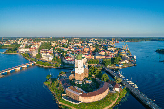 Vyborg Castle and Saint Olaf Tower stand proudly on an island, overlooking the city and Vyborg Bay in Russia during a bright sunny day