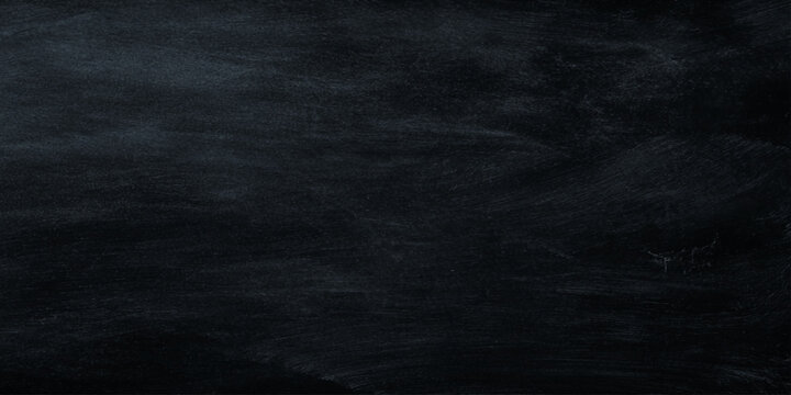 Dark textured black background with scratched and smudged chalkboard surface for design and education concepts