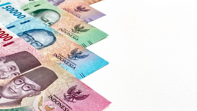Brightly colored Indonesian rupiah banknotes with space for text. Conceptually, they represent the country's financial system and monetary circulation.