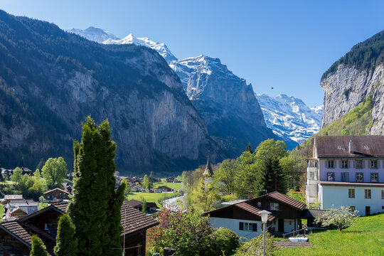 Amazing view of the picturesque alpine town of Lauterbrunnen, Switzerland. The village church and the Staubbach Falls in Lauterbrunnen