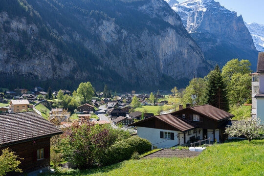 Famous Lauterbrunnen town and Staubbach waterfall, Bernese Oberland, Switzerland. Valley with green meadows. 