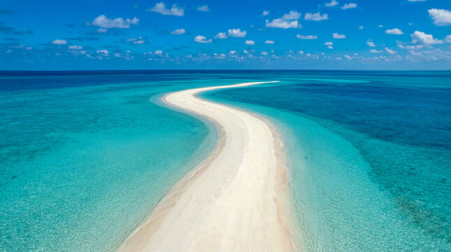 Aerial view of curving white sandbar in shallow gradient blue ocean