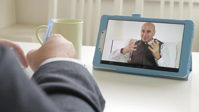 Video Business Meeting Between Two Businessmen's Using an Electronic Tablet. Online Application Via a Mobile Internet Connection.