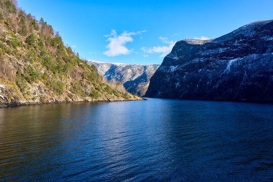 Magnificent Panoramic View of Deep Blue Norwegian Fjords with Snow-Capped Mountain Peaks on the Scenic Ferry Journey to Flam Village