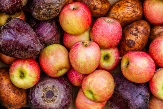 Assortment of fresh fruit and veg together apples beets and potatoes