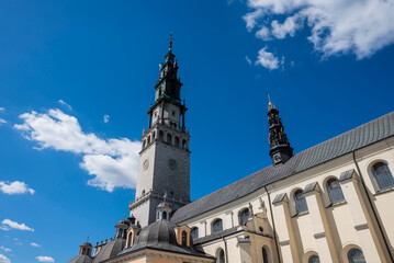 Obraz premium facade of Jasna Gora Monastery in Czestochowa, Poland, set against a bright blue sky.