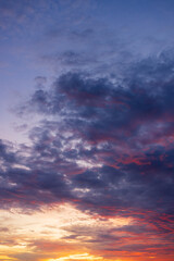 Fototapeta premium Vibrant Sunset Sky with Dramatic Clouds,A breathtaking view of a dramatic sunset with a vibrant mix of fiery orange, deep red, and rich purple hues painting the sky above the horizon, capturing.