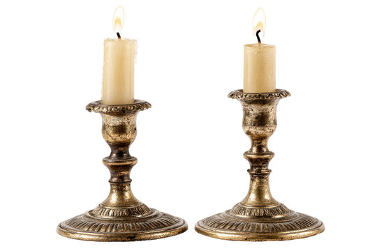 Antique brass candlesticks with lit candles isolated on transparent background.