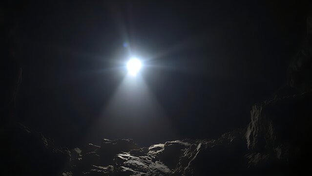 A single beam of light from a helmet lamp illuminates a dark cave.