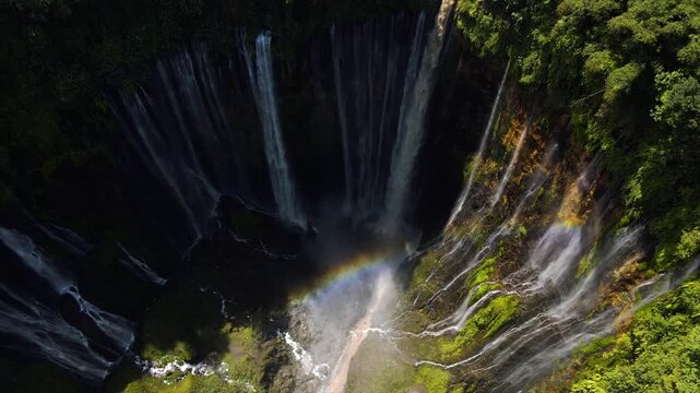 Stunning 4K aerial view of Tumpak Sewu waterfall curtains in East Java, Indonesia.