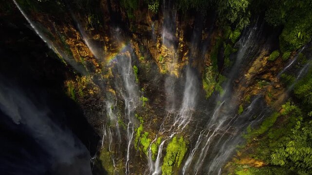 Stunning 4K aerial view of Tumpak Sewu waterfall curtains in East Java, Indonesia.