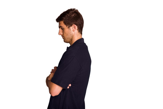 Dark polo shirt is being worn in profile against white backdrop, showing crossed arms, copy space