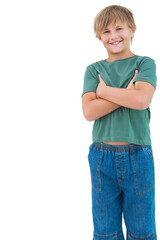 Fototapeta premium Child standing arms crossed smiling on white backdrop wearing green shirt, blue jeans, copy space