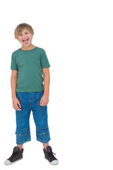 Fototapeta premium Child boy standing sticking out tongue on white backdrop wearing green tee, denim pants, copy space
