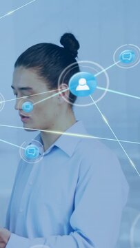 Vertical video: IT pro tapping device and speaking starting network icons showing links over torso