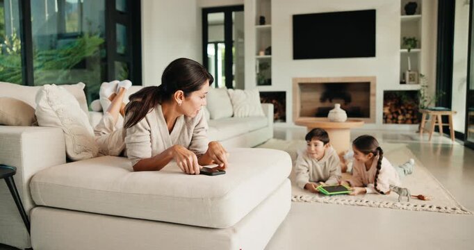 Mom, children and discipline with tablet in home for obedience, parenting or control. Mother, siblings and stop with argument, fight or disagreement on technology in living room dispute for behaviour