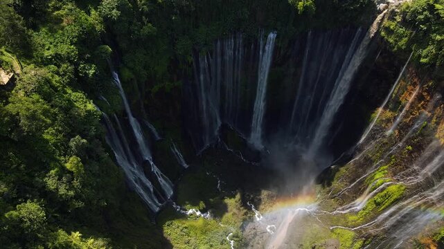 Stunning 4K aerial view of Tumpak Sewu waterfall curtains in East Java, Indonesia.