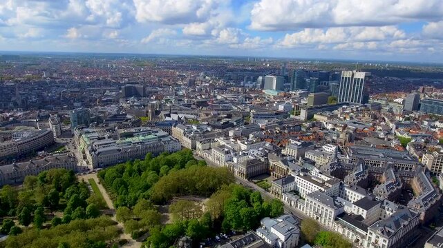 4K aerial view of Brussels with Brussels Park, Saint Michael and Saint Gudula Cathedral and the Northern Quarter business district skyscrapers in the Belgian capital under spring sky.