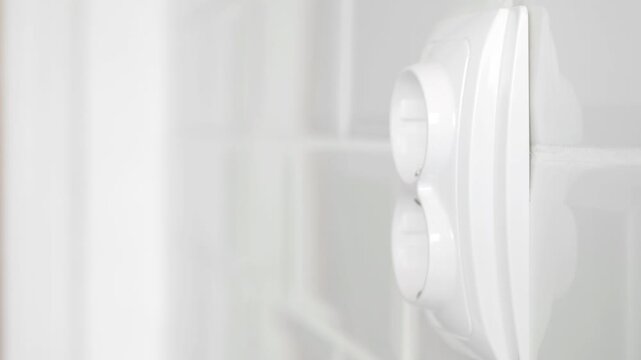 Shooting with a Man Disconnecting a Plug from the Electrical Outlet, Powering Off the Electricity of an Appliance at Home.