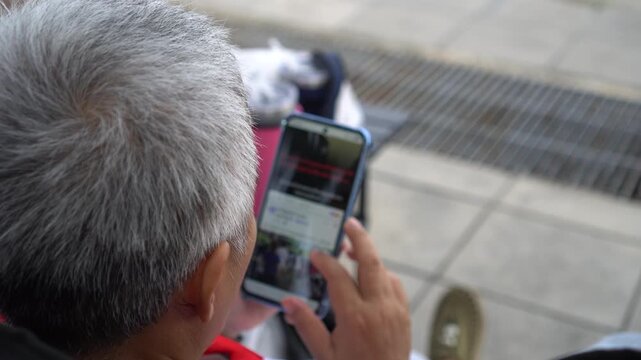 Elderly people using Mobile phones in posts social media chatting relaxing in home