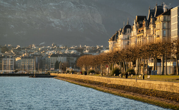 Geneva lake promenade with historic buildings and mountains