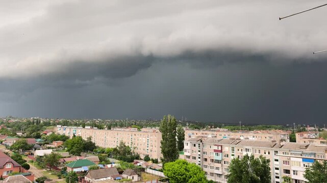 Dark stormy sky over city with lightning strikes and thunderclouds, summer storm approaching