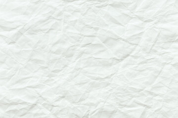 Naklejka premium Crumpled white paper texture with visible creases and folds.