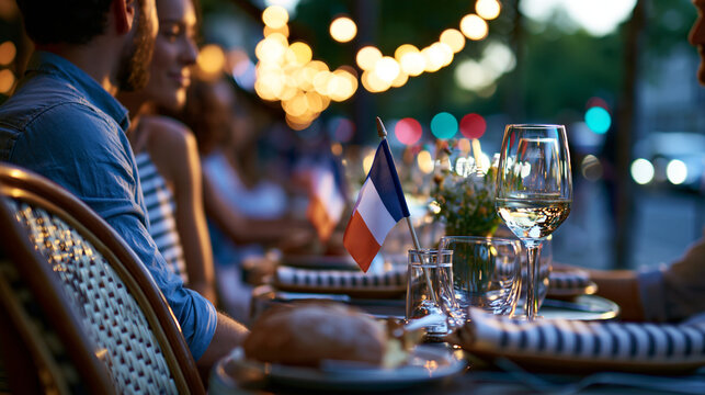 Romantic couple dining in a Paris street cafe on Bastille Day in France with French flag on the table under soft golden evening light