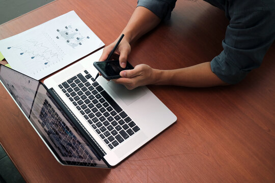 Businessman Using Smartphone And Laptop