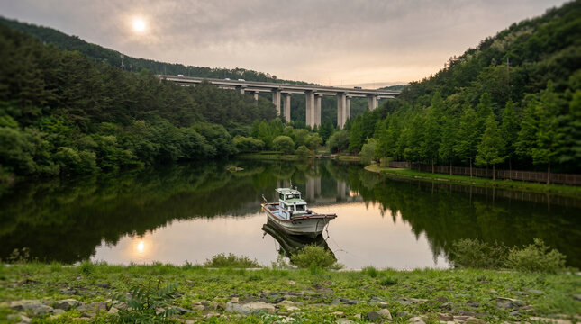 boats on the lake
Serene Riverside Landscape with Fishing Boat and Bridge in Forest Valley at Sunset
노을 지는 숲 계곡 강변과 배, 그리고 대교가 어우러진 평온한 풍경