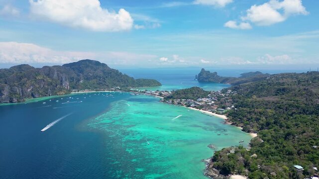 Phi Phi Island, Thailand : Aerial drone footage of the stunning Koh Phi Phi, famous island in Andaman sea of Thailand with turquoise water and white sand beach. Taken with a cinematic tilt up motion