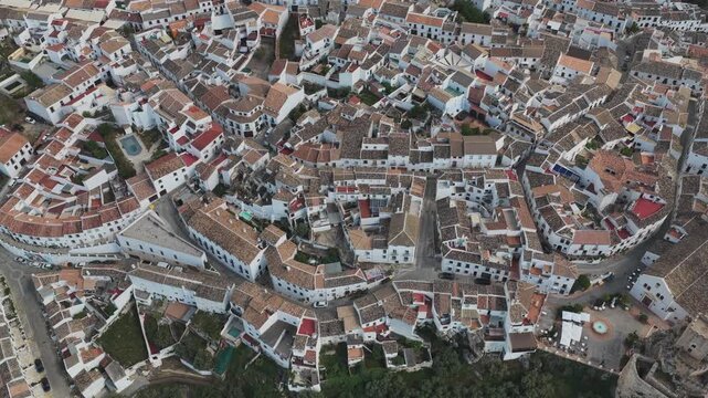 Aerial view of the traditional white houses and terracotta rooftops of the historic village of Zuheros, Andalusia, Spain.