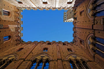 Fototapeta premium View to the sky in Palazzo Pubblico, an historic palace on the Piazza del Campo in Siena and one of the principal landmarks of the historic center.