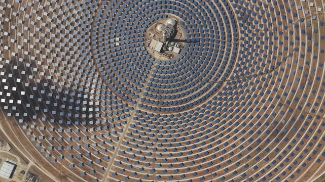 Aerial view of Torresol Energy Gemasolar plant with concentric circles of heliostat mirrors reflecting sunlight in Fuentes de Andalucia, Andalucia, Spain.