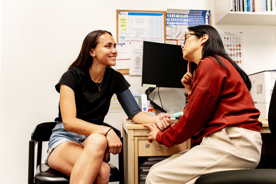 Healthcare professional conducting blood pressure check with patient